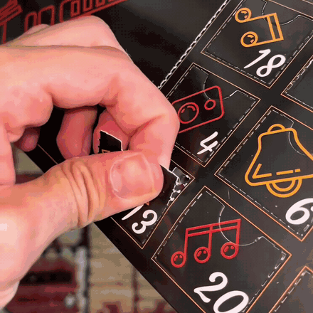 Opening a door of the guitar pick advent calendar